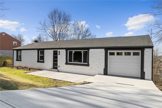 ranch-style house featuring a garage and a front lawn