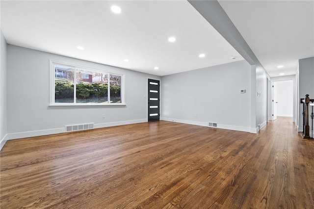 unfurnished living room with dark wood-type flooring