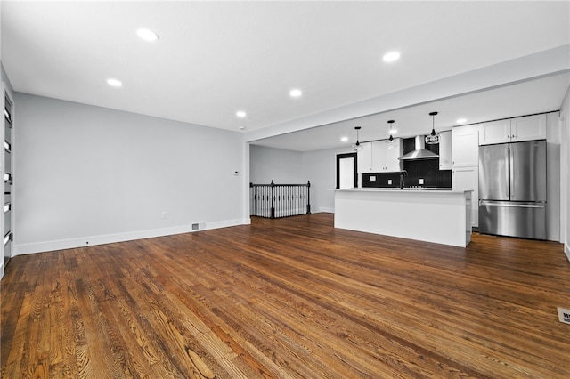 unfurnished living room with hardwood / wood-style flooring