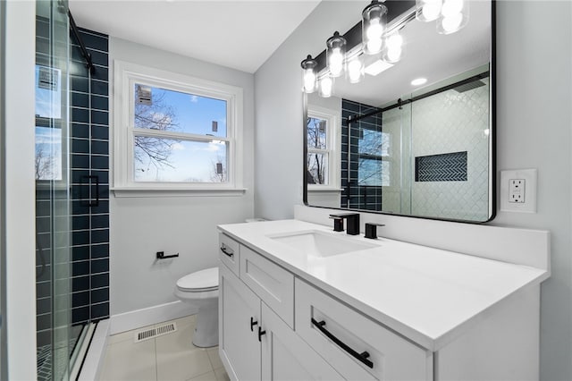 bathroom with tile patterned floors, vanity, a shower with shower door, and toilet