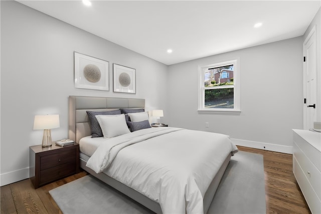 bedroom with dark hardwood / wood-style flooring