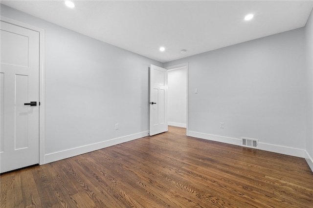 unfurnished room with dark wood-type flooring