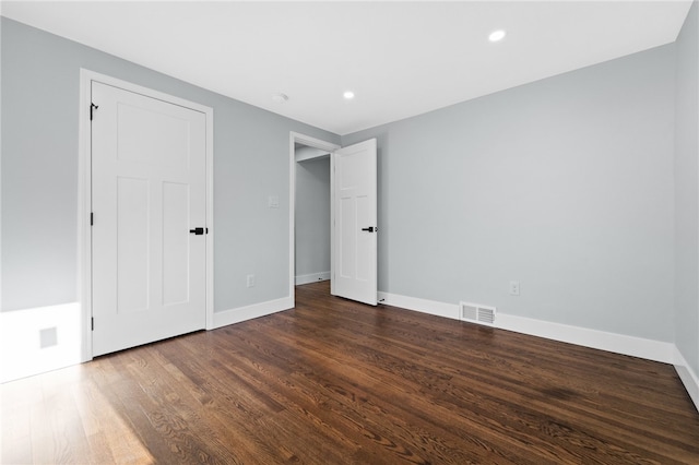 unfurnished bedroom with dark hardwood / wood-style floors