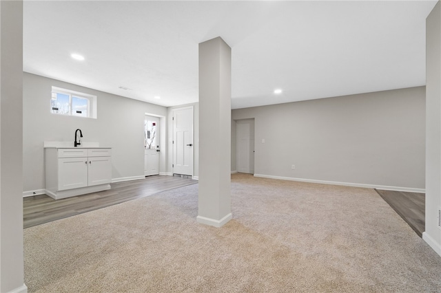 basement featuring carpet and sink