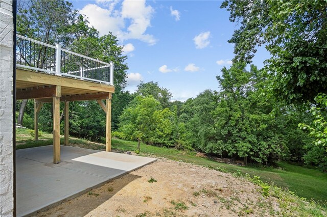 view of yard with a patio and a wooden deck