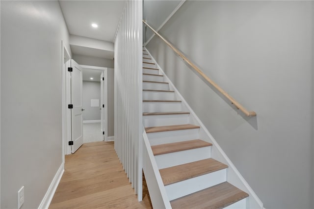 stairs with wood-type flooring