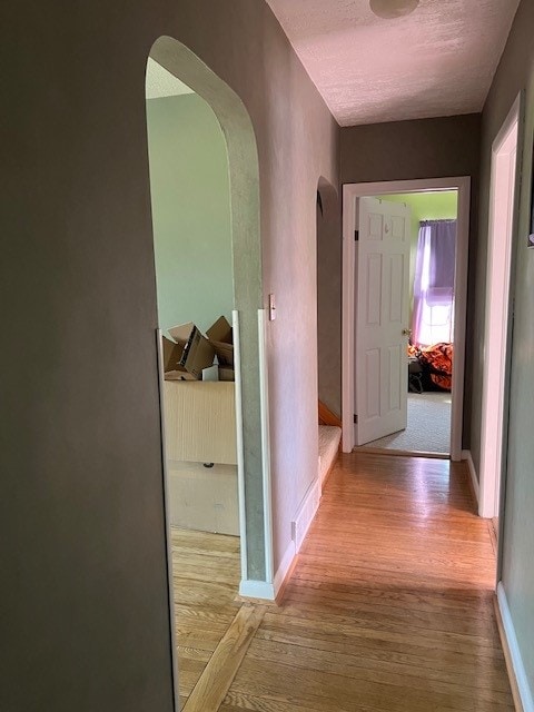 corridor with light hardwood / wood-style flooring