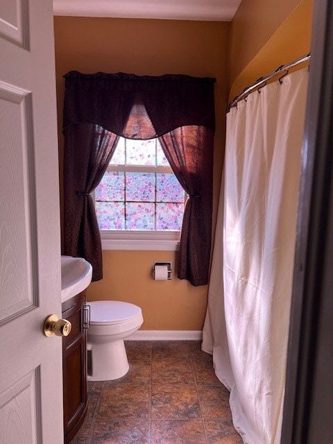 bathroom with toilet, tile flooring, and vanity