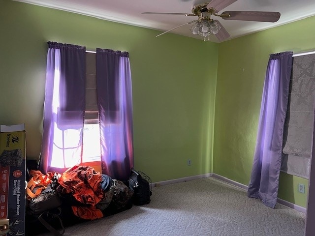 unfurnished bedroom with ceiling fan and light carpet