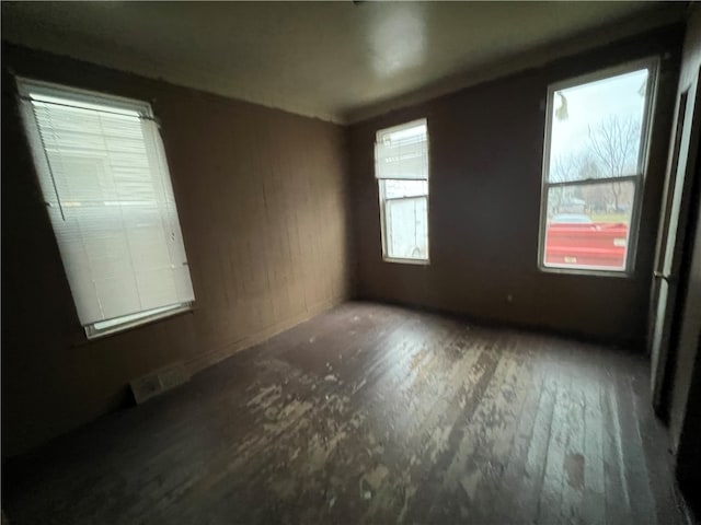 empty room with dark hardwood / wood-style floors