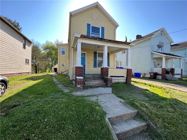 view of front of home featuring a front yard and covered porch