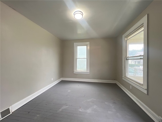 unfurnished room with dark hardwood / wood-style floors