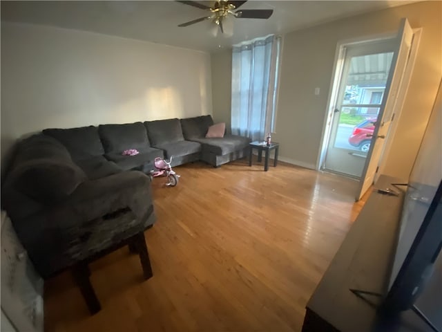 living room featuring light wood-type flooring and ceiling fan