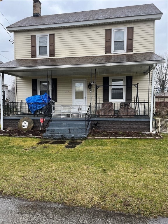 view of front facade with covered porch and a front yard