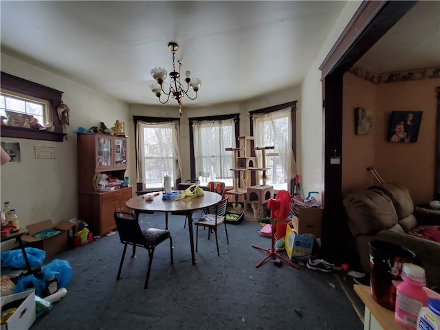 carpeted dining area featuring a chandelier