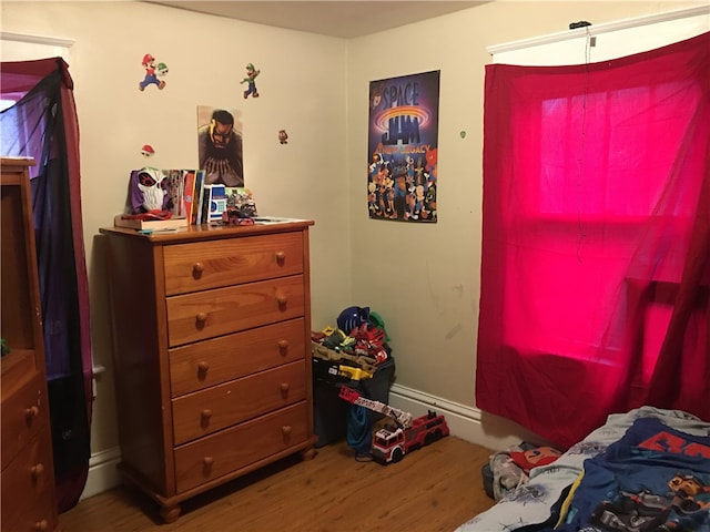 bedroom with hardwood / wood-style flooring