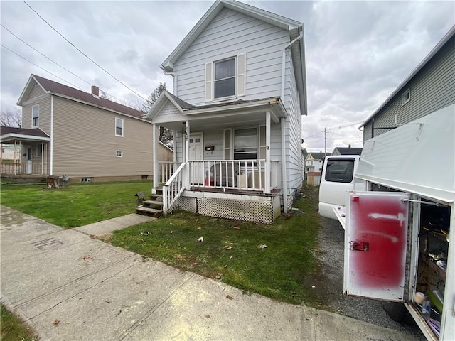 view of front property featuring a porch and a front yard