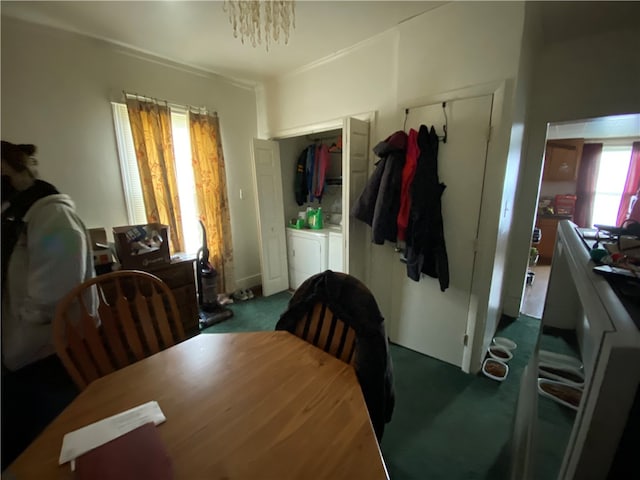 dining area with washer and dryer and dark colored carpet