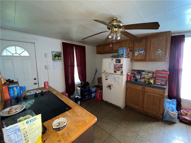 kitchen with ceiling fan, tile patterned flooring, and white refrigerator