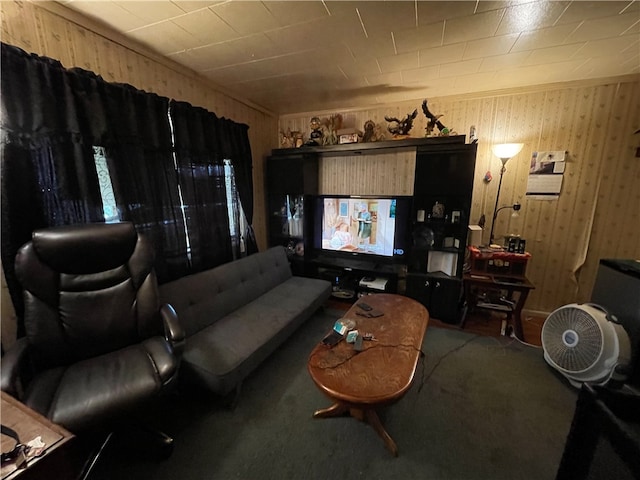 carpeted living room with wood walls