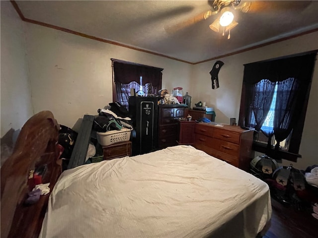 bedroom with ornamental molding and ceiling fan