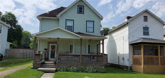 front facade featuring a porch and a front yard