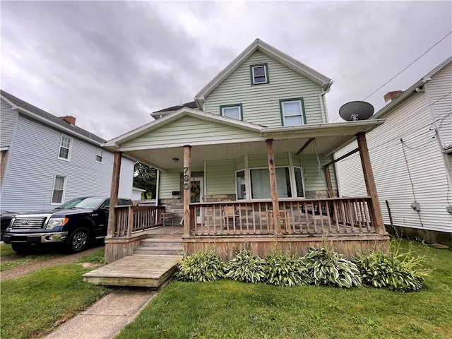 view of front of house featuring a porch and a front yard