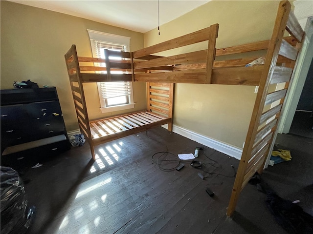 bedroom with dark wood-type flooring