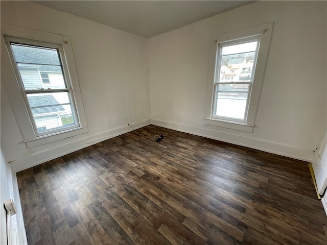 unfurnished room featuring dark hardwood / wood-style flooring