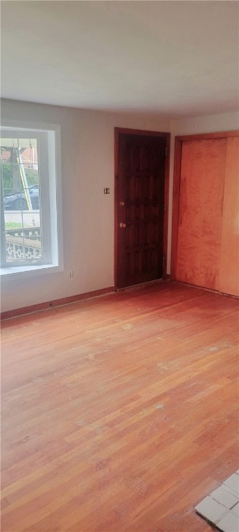 spare room with light wood-type flooring