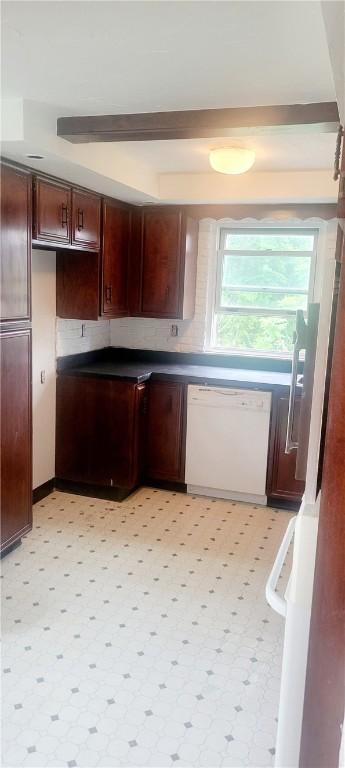 kitchen with backsplash, light tile floors, and white dishwasher