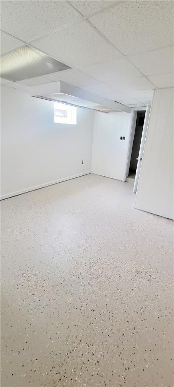 basement featuring a paneled ceiling