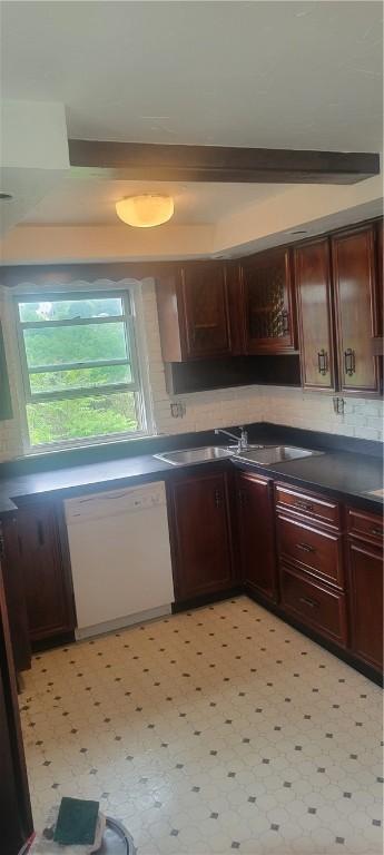 kitchen featuring sink, dishwasher, light tile flooring, and backsplash