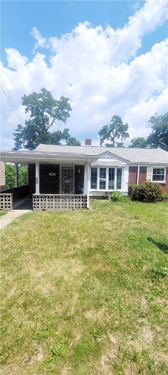 ranch-style house with a front lawn