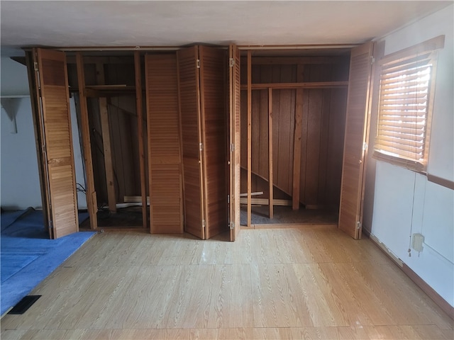 unfurnished bedroom featuring two closets