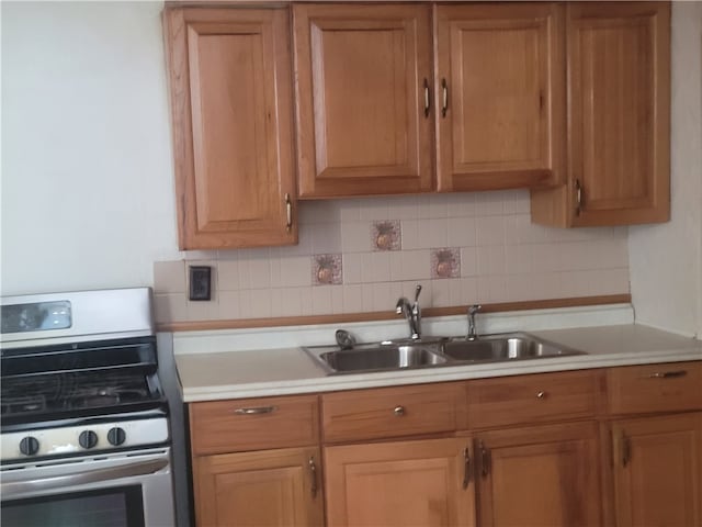 kitchen featuring sink, backsplash, and range