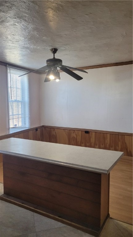 interior space with ceiling fan and light tile floors