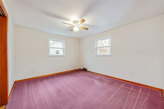 spare room featuring carpet flooring and ceiling fan