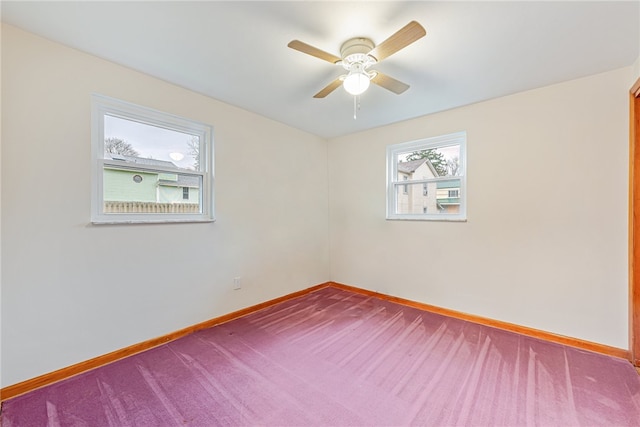 unfurnished room with ceiling fan and carpet flooring