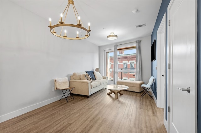 sitting room featuring light hardwood / wood-style flooring and a notable chandelier