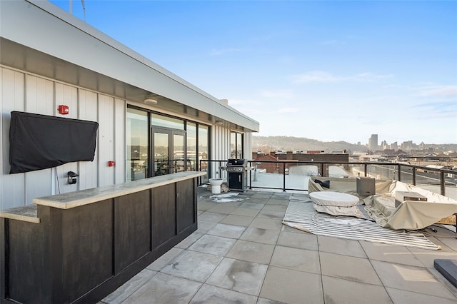 view of patio with a grill and a balcony