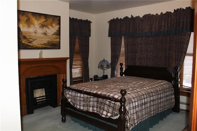 carpeted bedroom with a baseboard heating unit