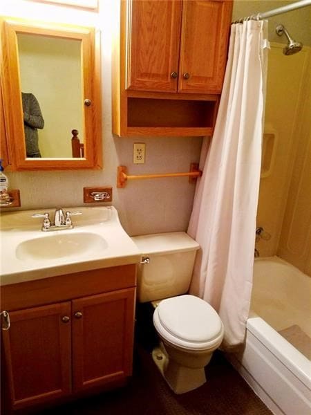 full bathroom with toilet, vanity, and shower / tub combo with curtain