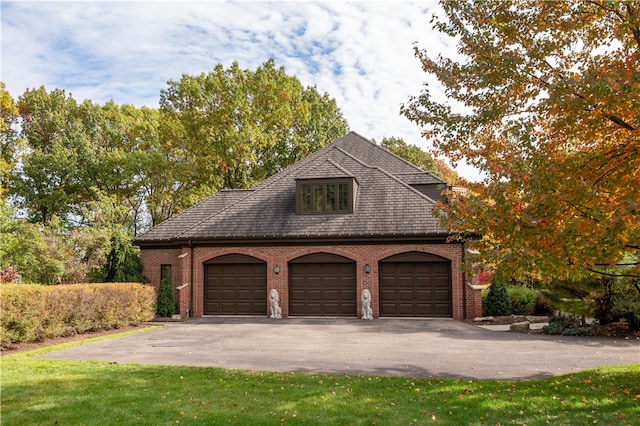 garage featuring a lawn