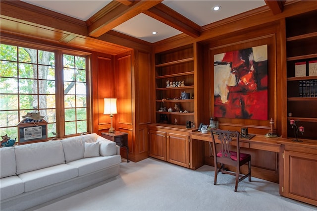 office with coffered ceiling, built in desk, built in shelves, and light colored carpet