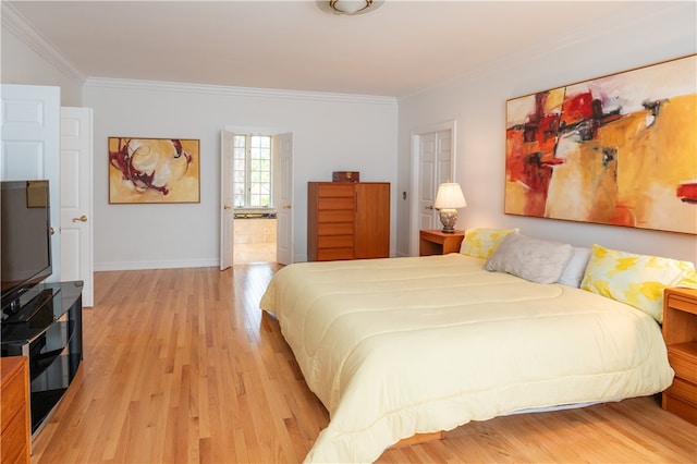 bedroom featuring ornamental molding and light wood-type flooring