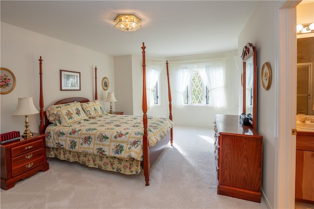 carpeted bedroom featuring ensuite bath