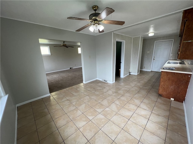 kitchen with sink, ceiling fan, and light tile patterned floors