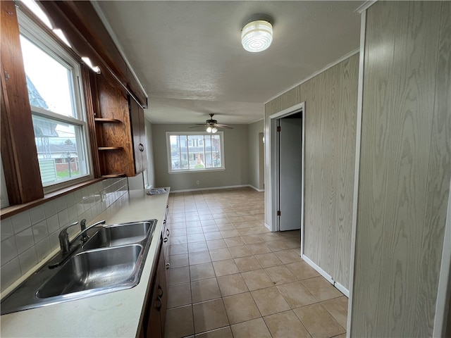 kitchen with ceiling fan, a wealth of natural light, sink, and tasteful backsplash