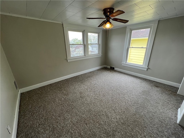 spare room featuring ceiling fan, carpet flooring, and crown molding